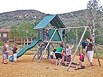 With a Lifetime Deluxe Swing Set the playground is a good spot to entertain the younger children.