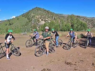A group of cyclists pose for the camera before setting out on a mountain biking tour.
