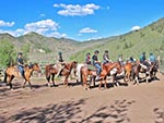 Mounted riders are preparing to start their journey.