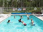 Youth play a game of pool ball in the Tabby Mountain Lodge's pool.