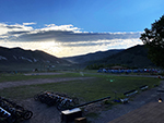 A view of the main activity field and tent city in the background.