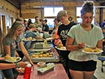 Guests dish up their food through a buffet style line.