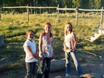 Three girls spend an evening roasting marshmallows.