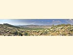 A panoramic scenic view of the hills and mountains around Reid Ranch.