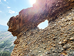 An interesting rock formation with a hole carved out by erosion.