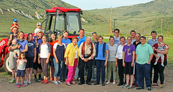 The Reid Family pose in front of a tractor.