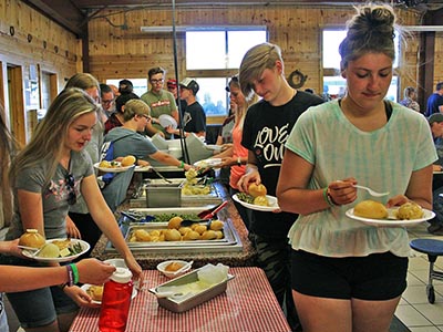 Guests dish up their food through a buffet style line.