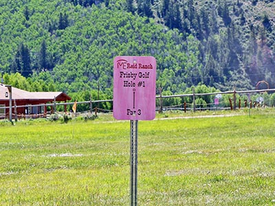 A sign showing where to start Frisbee Golf 'hole' one, and directions to the hoop.