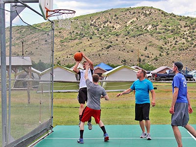 Jumping toward the hoop for a shot during a basketball game.