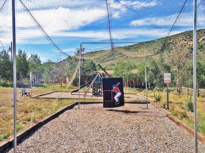 A Reid Ranch employee is ready to light the campfire at the Bunkhouse Fire Pit.