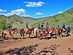 Mounted riders are preparing to start their journey.