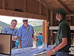 Looking out from inside the Tradin Post, an employee serves guests who sign-up for activities and check-out sports equipment.