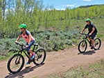 Two cyclists enjoy their mountain biking ride.