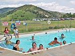 Now aware of the camera, the youth in the pool come closer for a snap-shot.