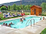 Young ladies play games in the swimming pool. The sauna is visible in the background.