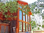 Outside angled view of the large front windows of the Red Creek Lodge.