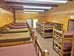 An inside of view of one Dorm in the Bunkhouse, bunk beds line the walls.