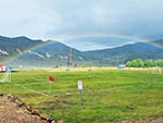 A rainbow arches over an open view of the Soccer Field.