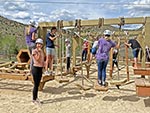 Lower Ropes Course showing some features: (foreground) horizontal net, swinging platforms, (background) swinging bars, hanging ropes, log tunnel, balance logs, upper and lower rope.